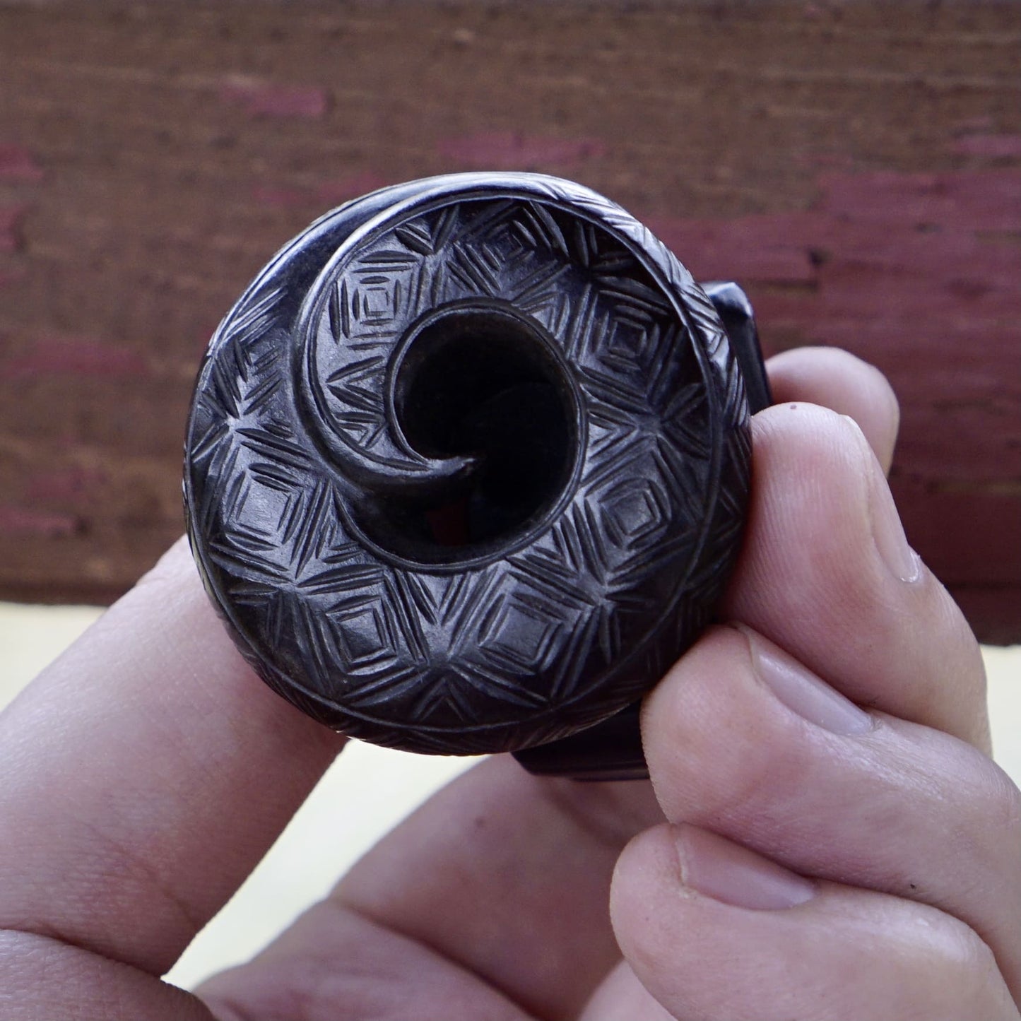 A fine round sculpture of a small dragon with black lacquer