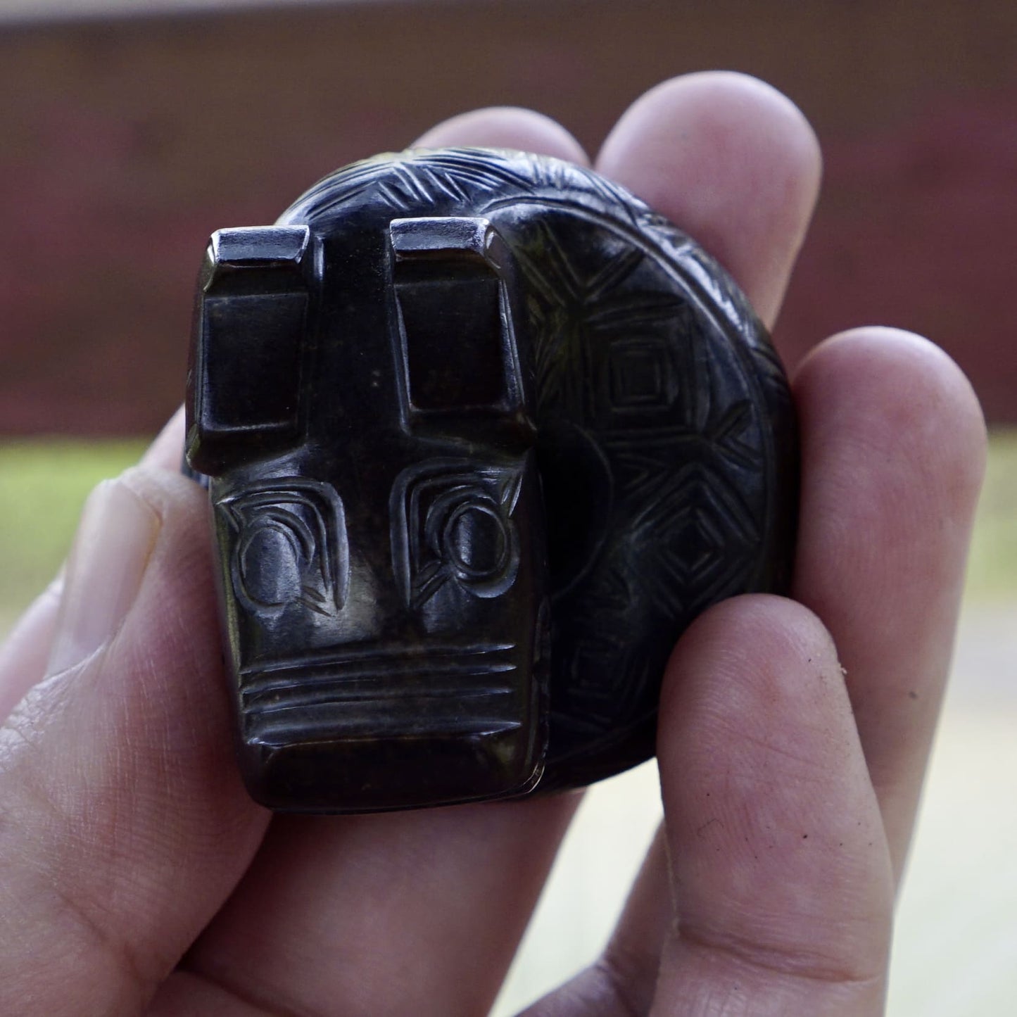 A fine round sculpture of a small dragon with black lacquer