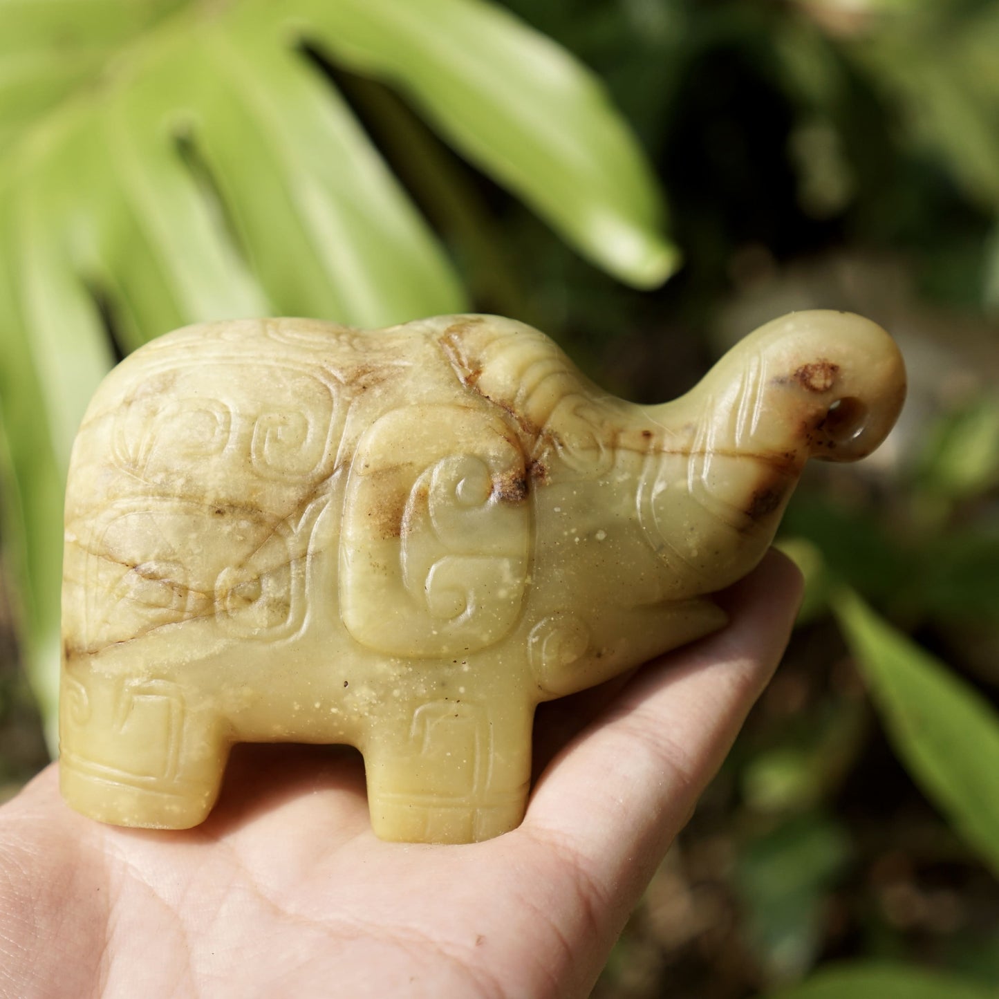 A round-carved jade elephant with inscriptions