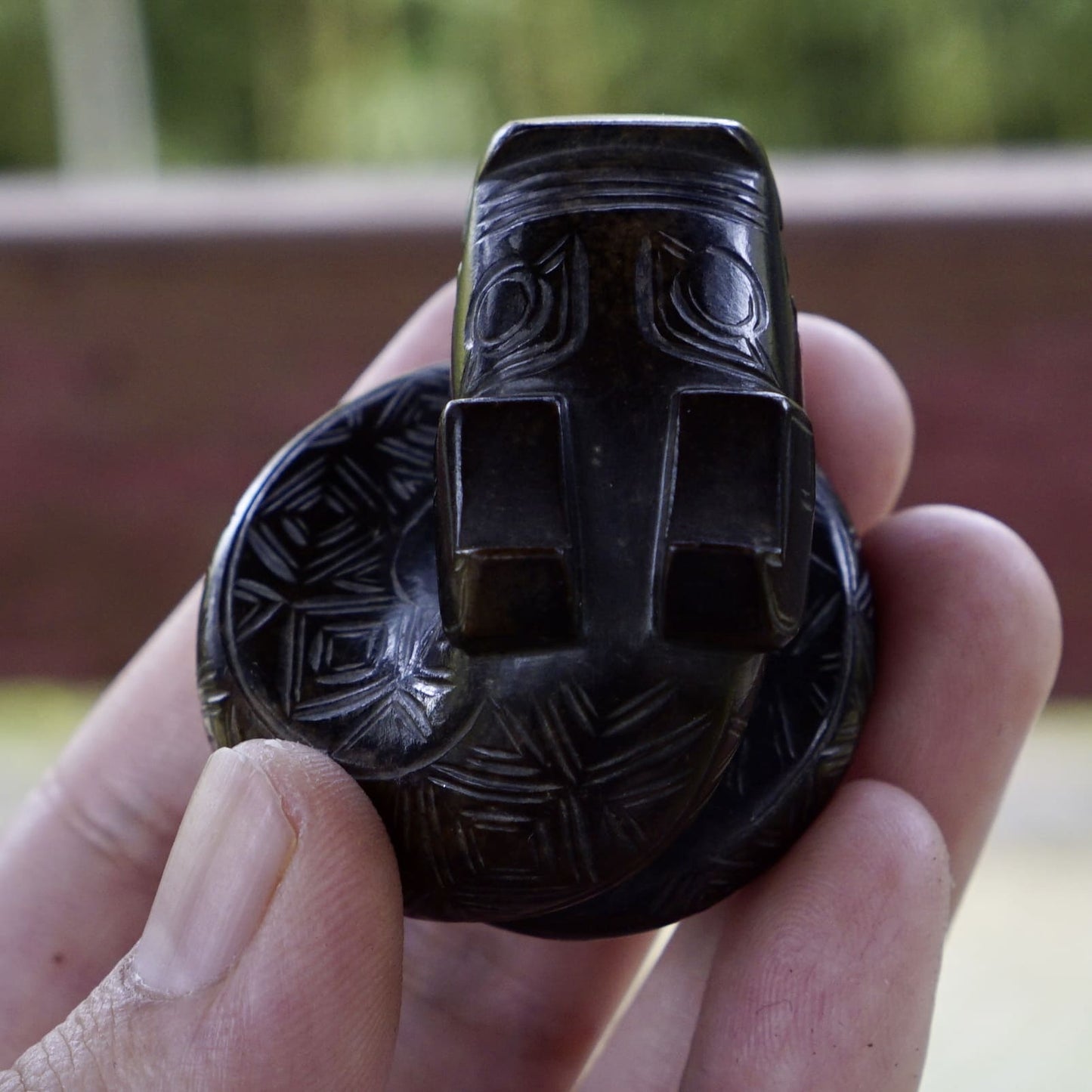 A fine round sculpture of a small dragon with black lacquer