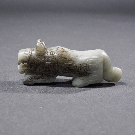 Mercury-stained white jade tiger with inscription