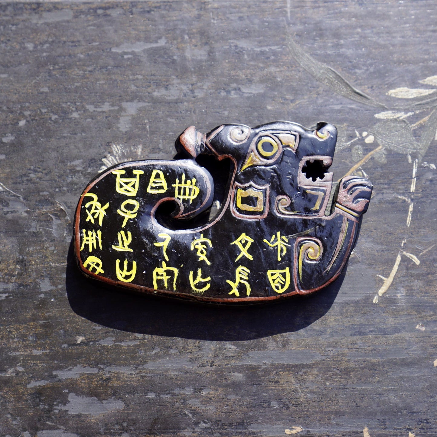 A double-sided lacquer-painted jade tiger with inscriptions