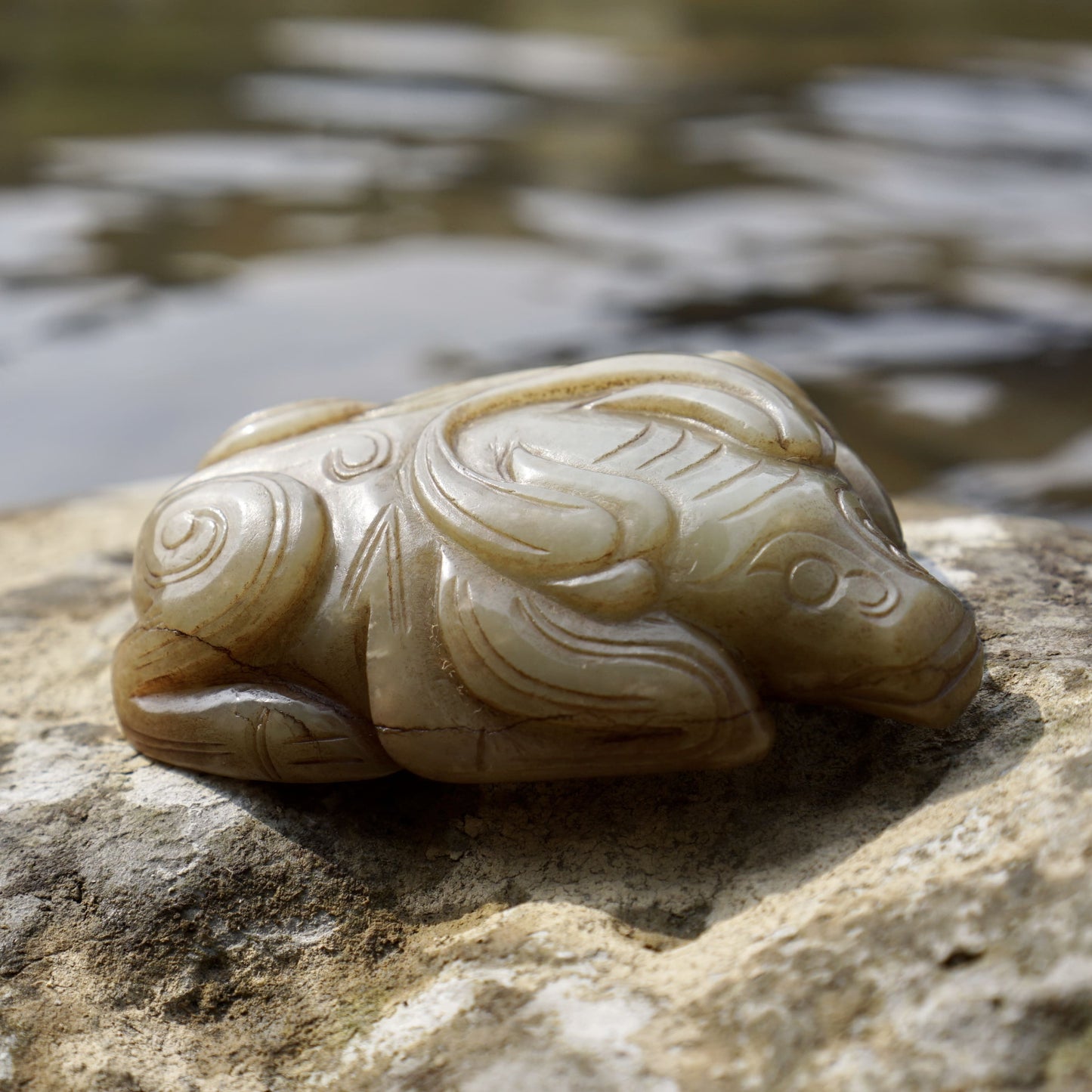 Round carved jade cow paperweight