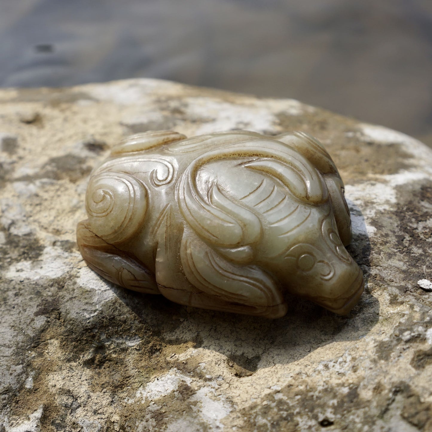 Round carved jade cow paperweight