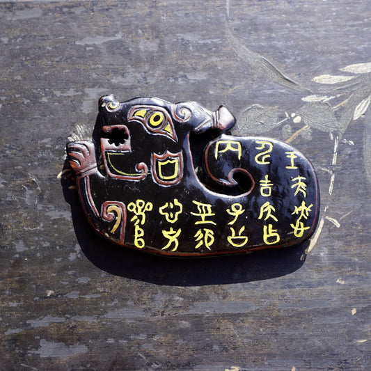 A double-sided lacquer-painted jade tiger with inscriptions