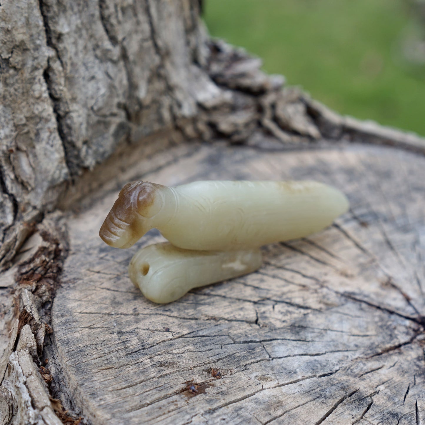 A white jade mantis with an inscription on the back