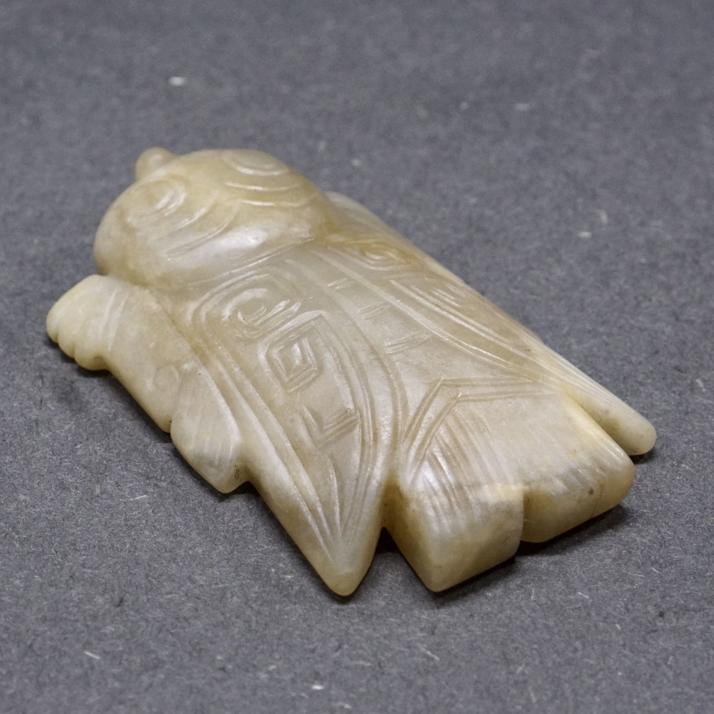 White jade with a circular pattern and a lying bird