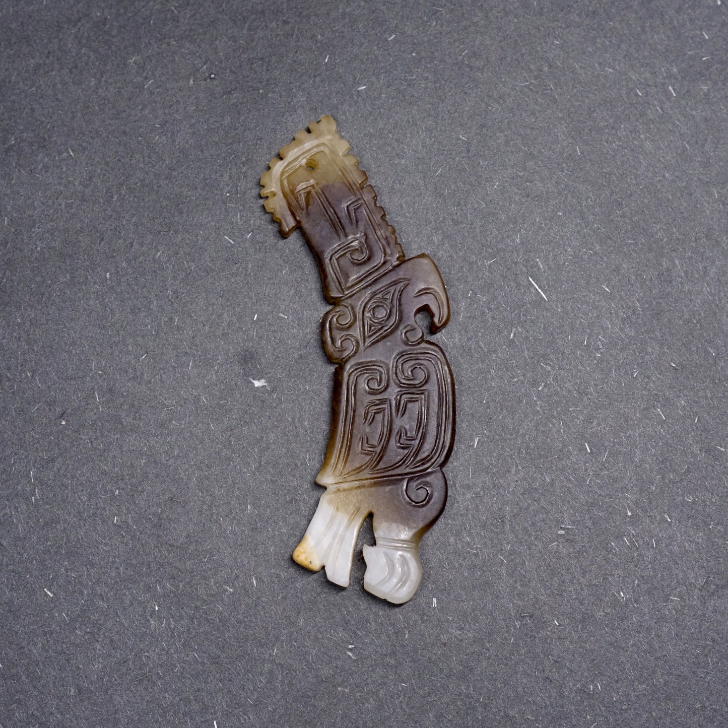 White jade pendant in the shape of a high-crowned parrot