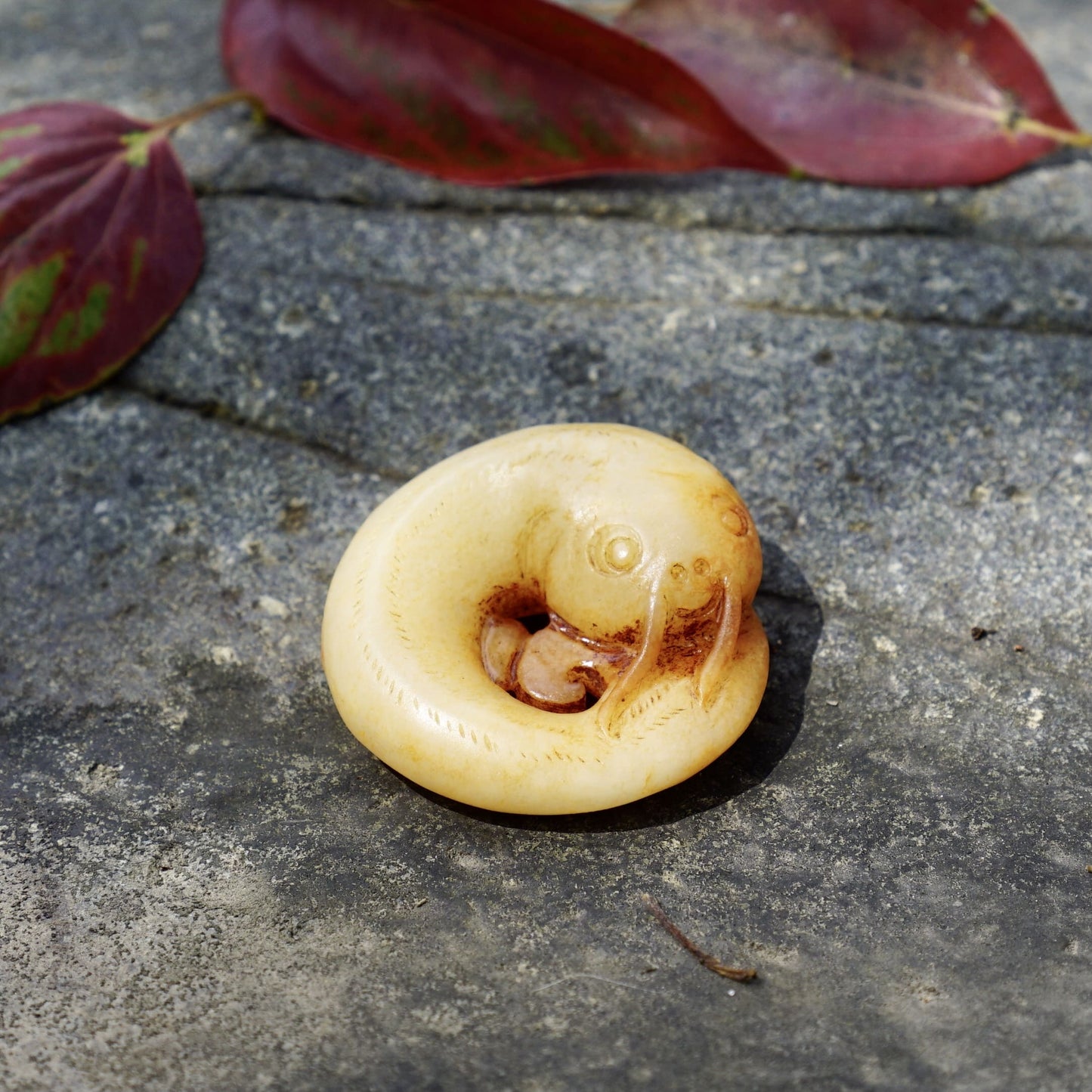 White jade catfish pendant with cinnabar stain