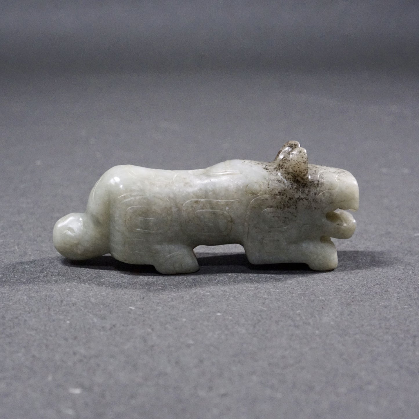 Mercury-stained white jade tiger with inscription