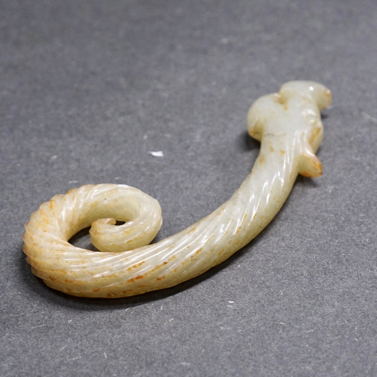 Twisted white jade hook-shaped dragon pendant