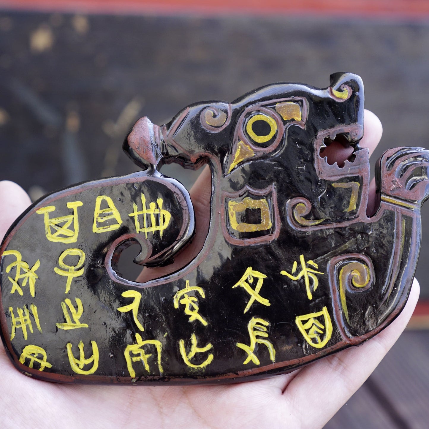 A double-sided lacquer-painted jade tiger with inscriptions