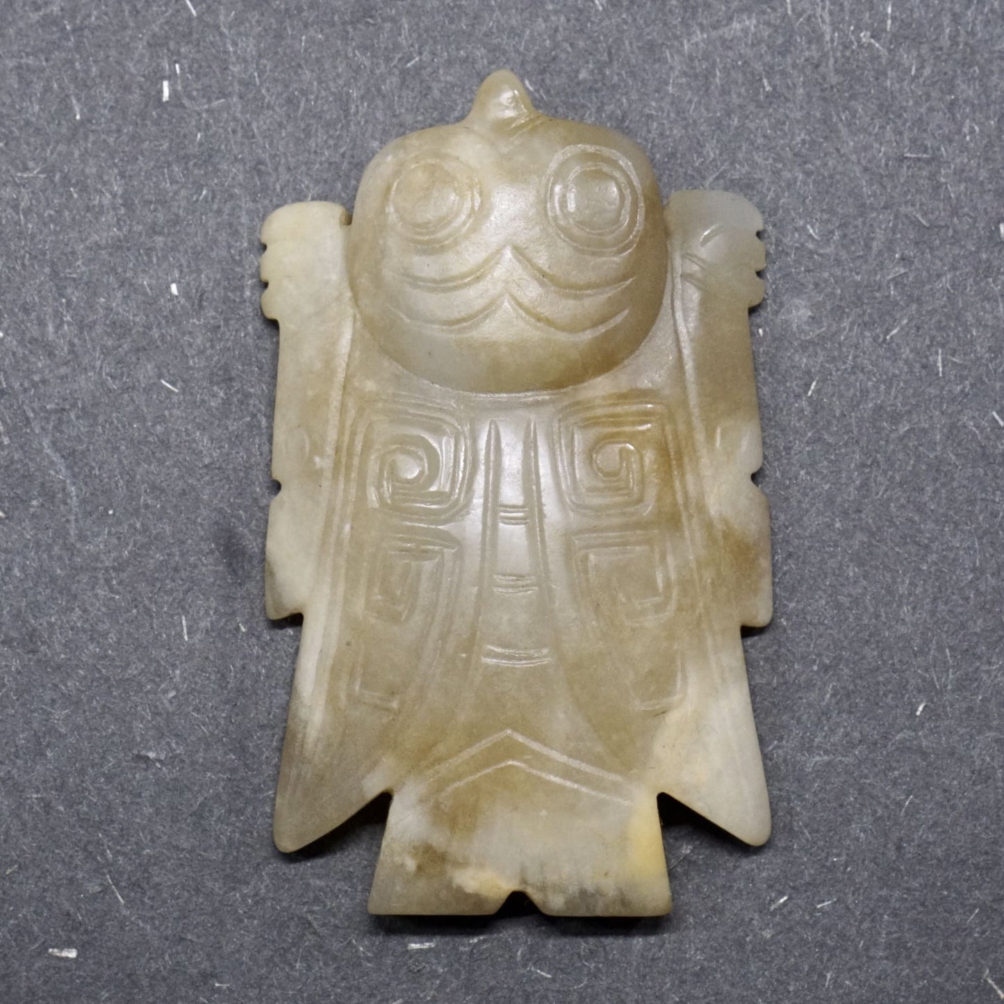 White jade with a circular pattern and a lying bird