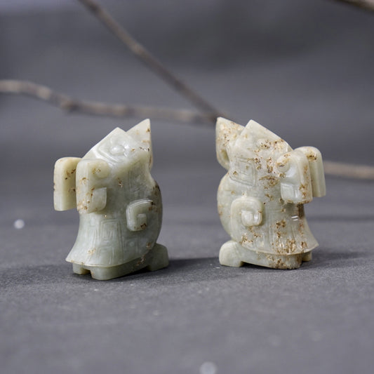 A pair of jade owls carved in the round