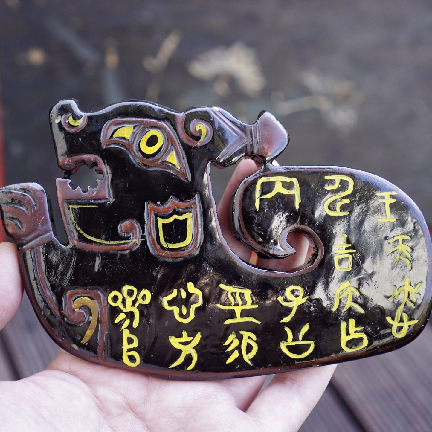 A double-sided lacquer-painted jade tiger with inscriptions