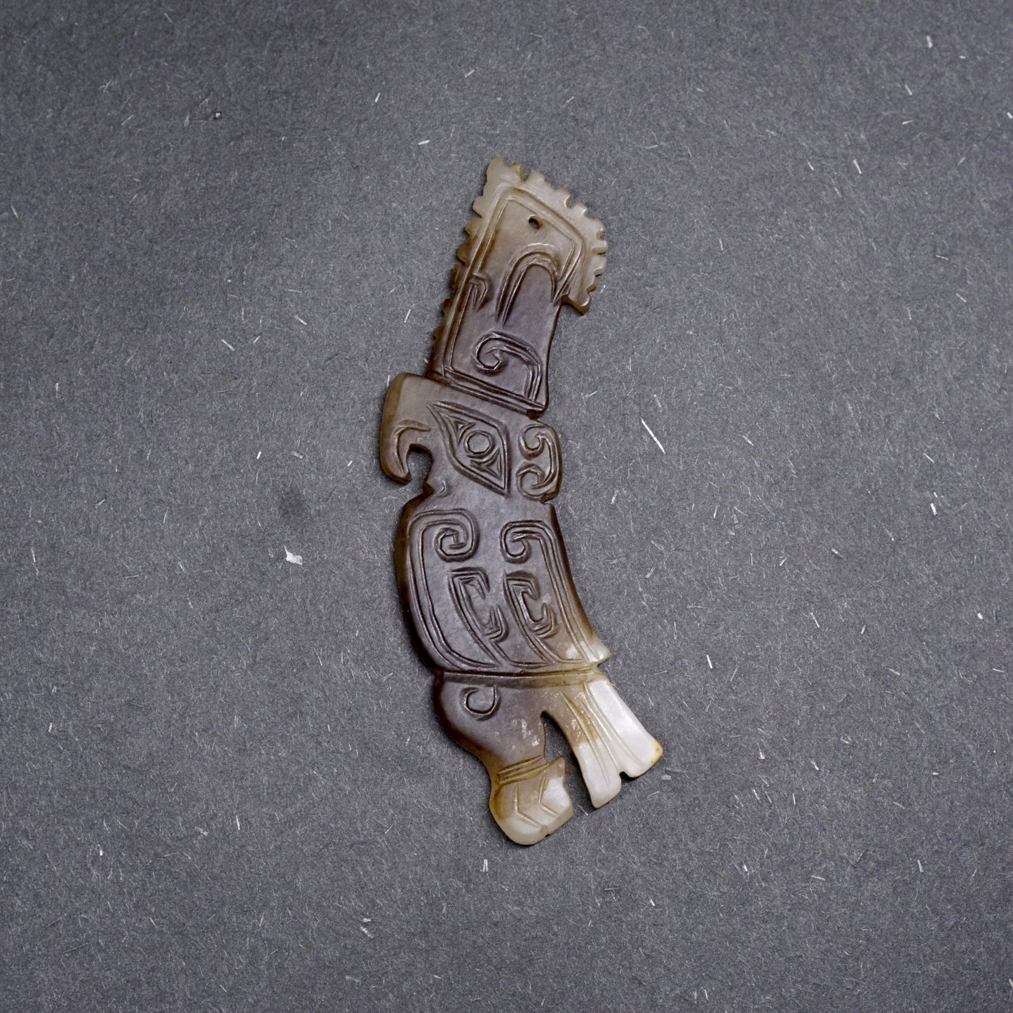 White jade pendant in the shape of a high-crowned parrot