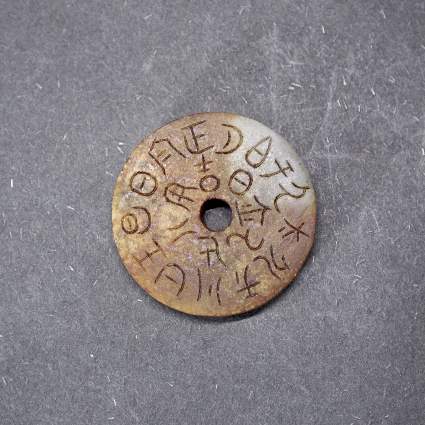 Double-sided jade bi with inscriptions and seal carvings