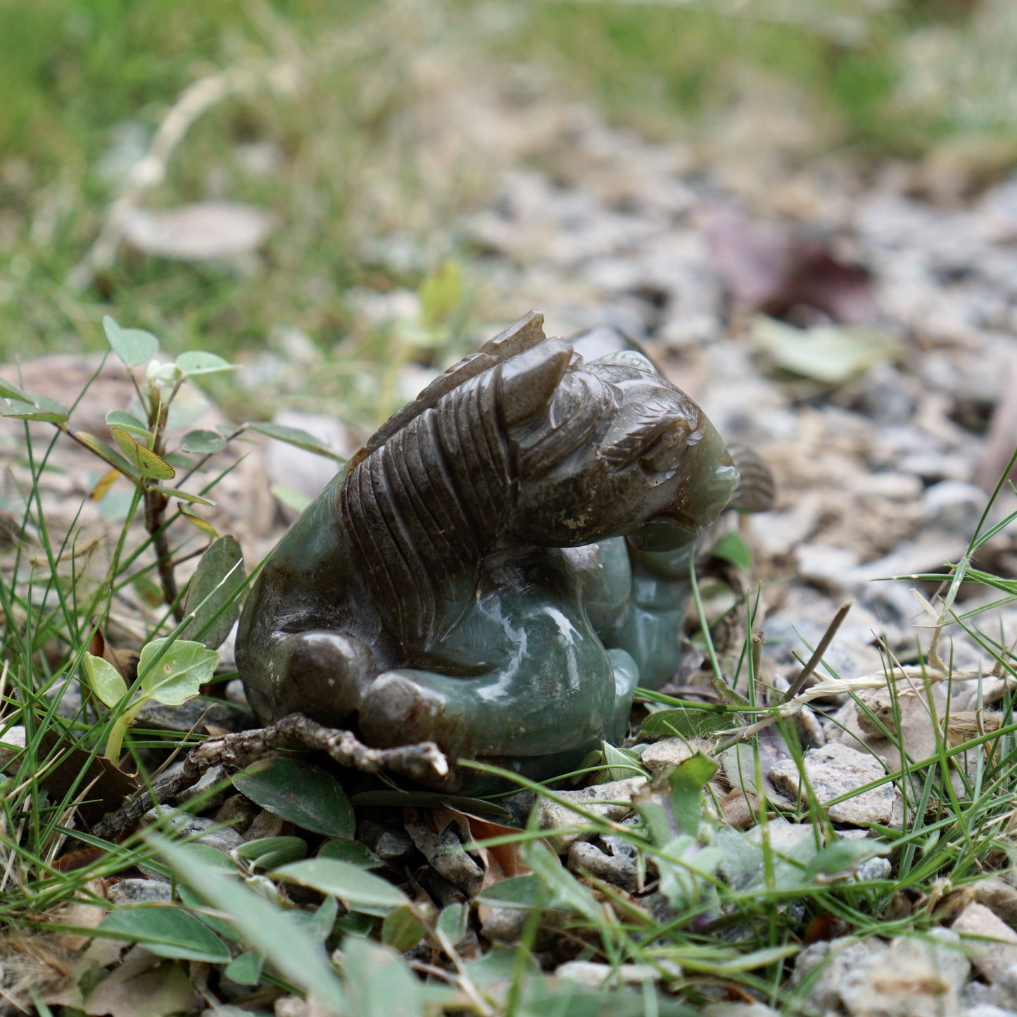 Jade round-carved sculpture of a reclining horse looking back