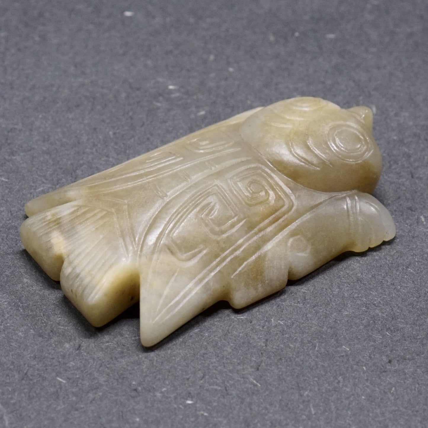 White jade with a circular pattern and a lying bird