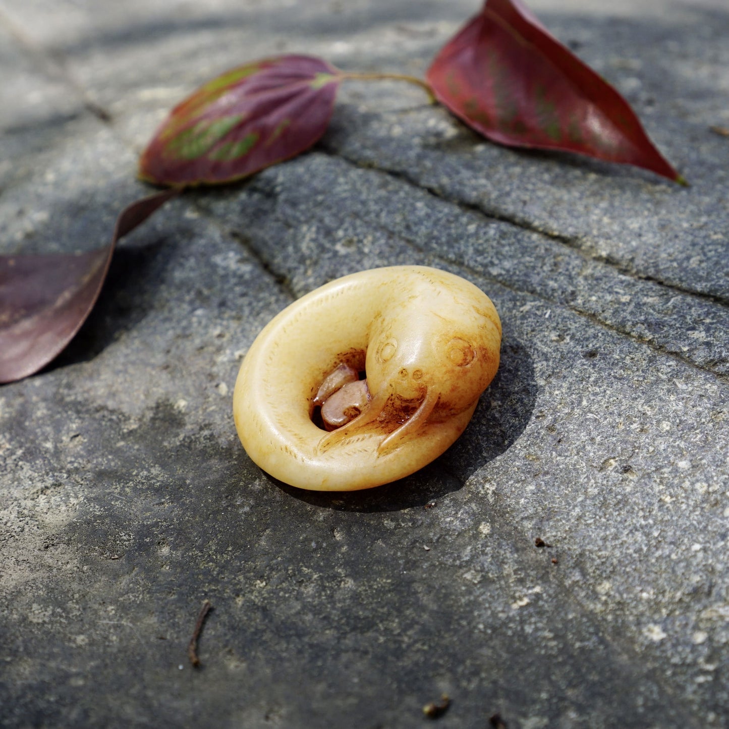 White jade catfish pendant with cinnabar stain