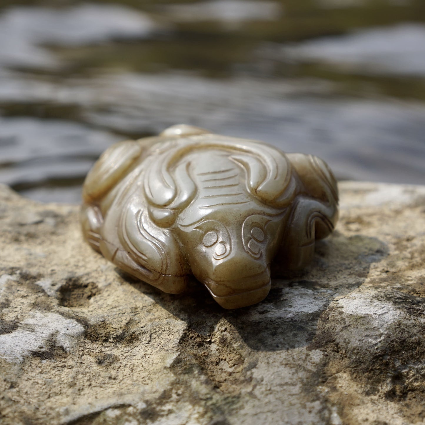 Round carved jade cow paperweight