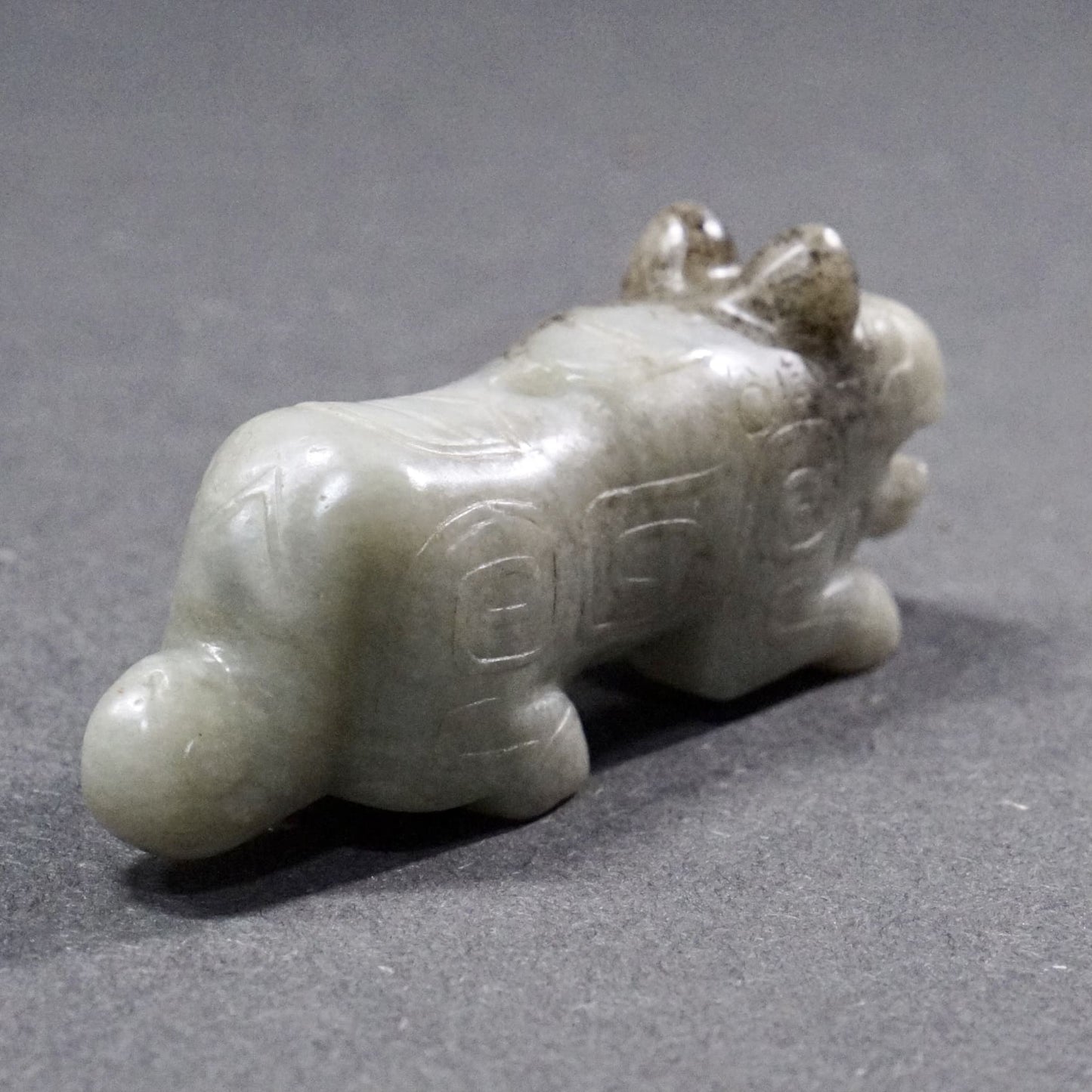 Mercury-stained white jade tiger with inscription