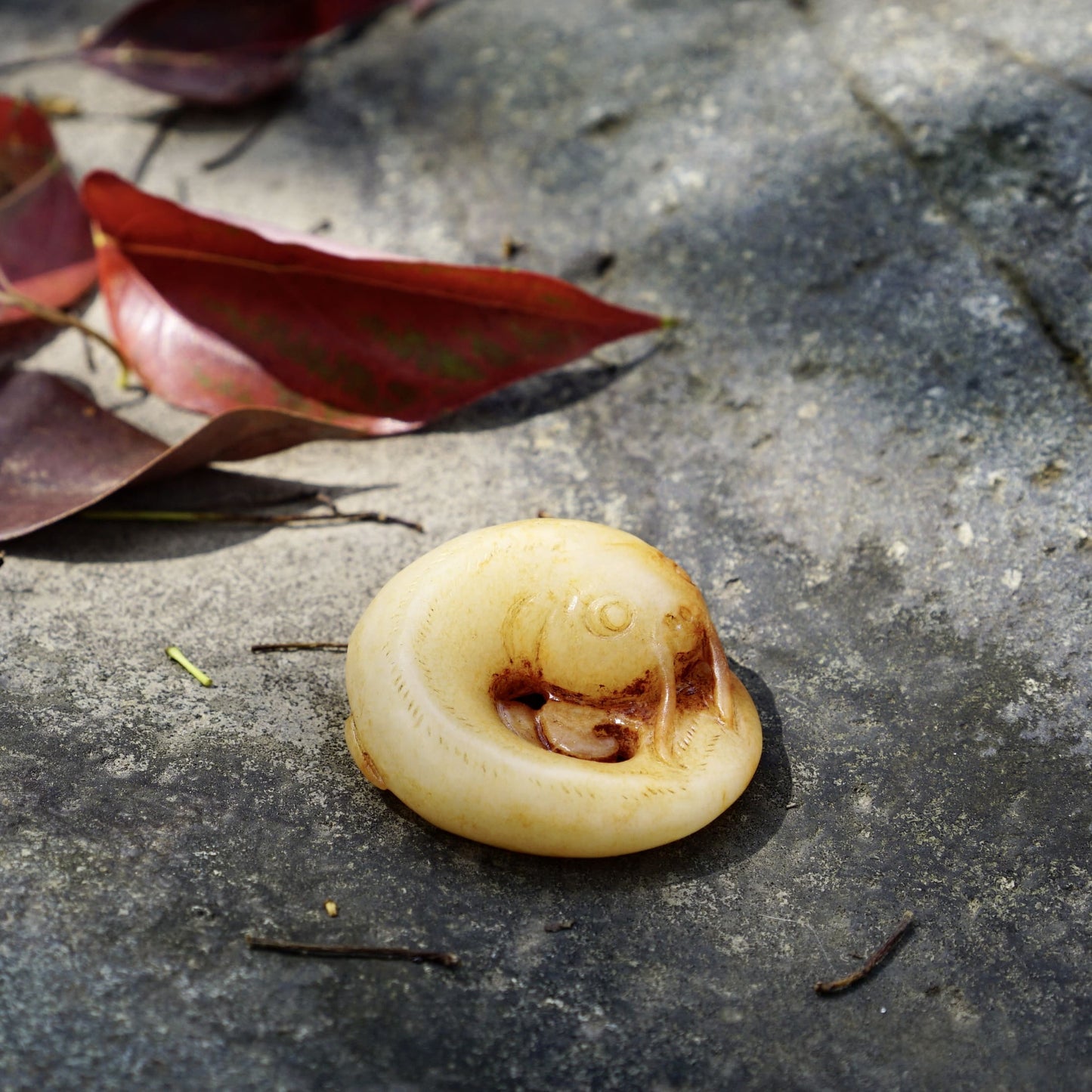 White jade catfish pendant with cinnabar stain