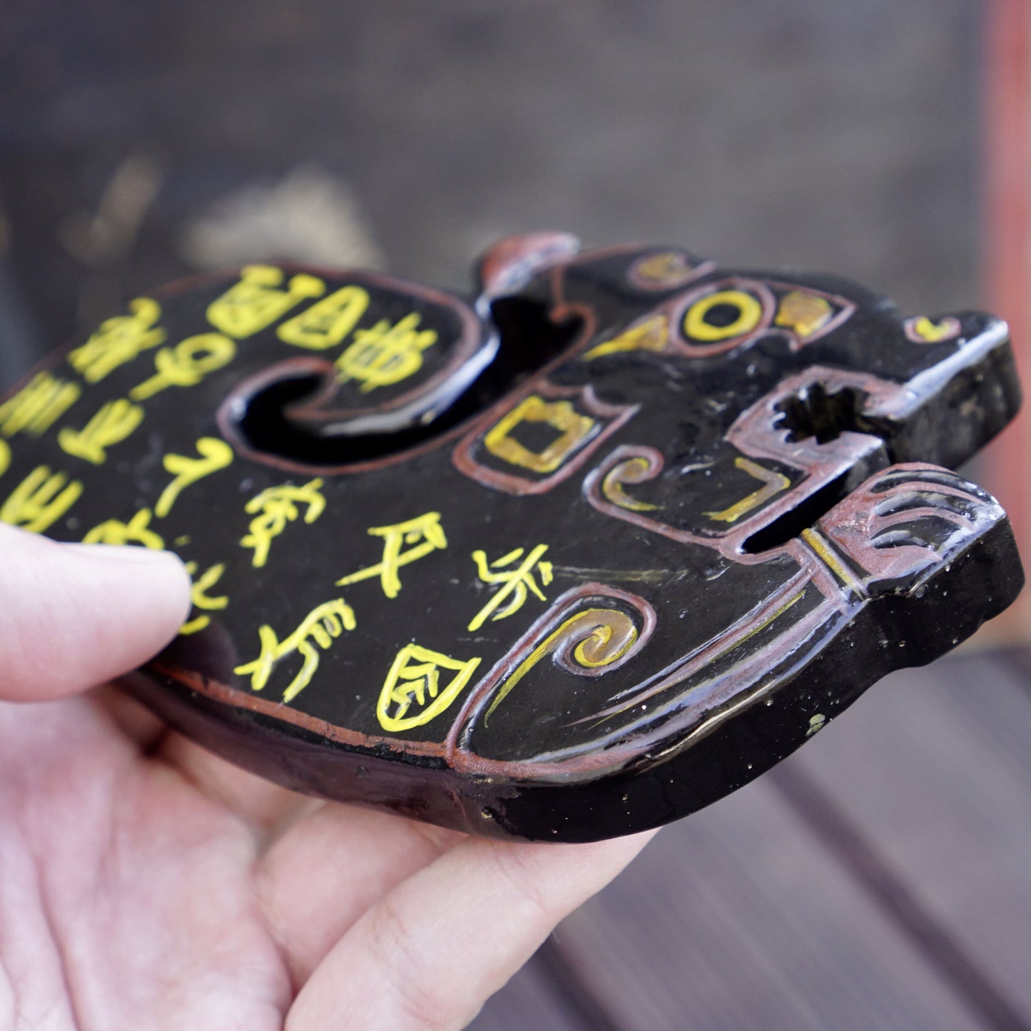 A double-sided lacquer-painted jade tiger with inscriptions