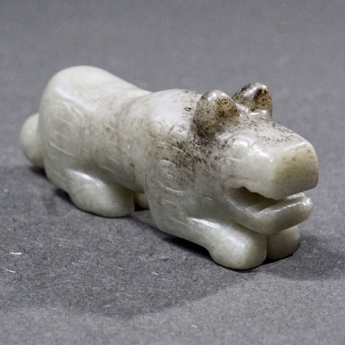 Mercury-stained white jade tiger with inscription