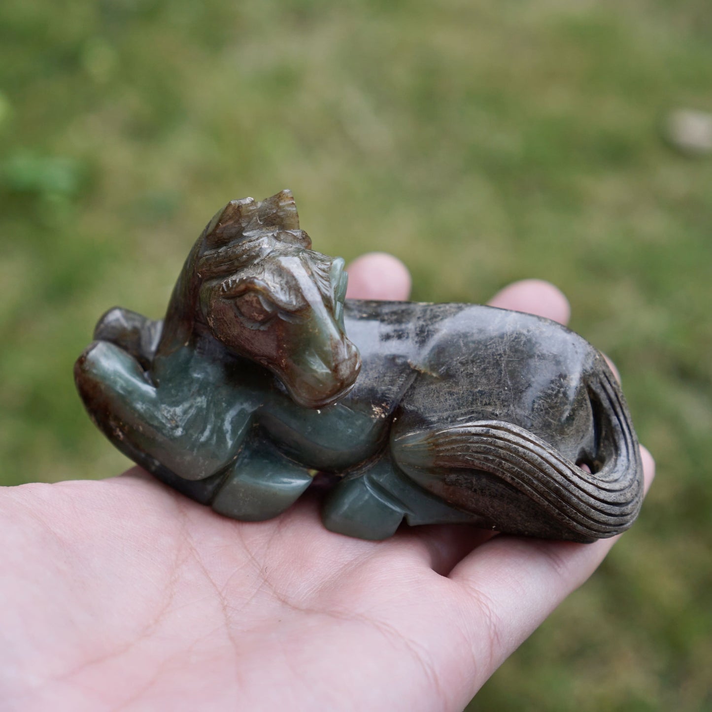 Jade round-carved sculpture of a reclining horse looking back