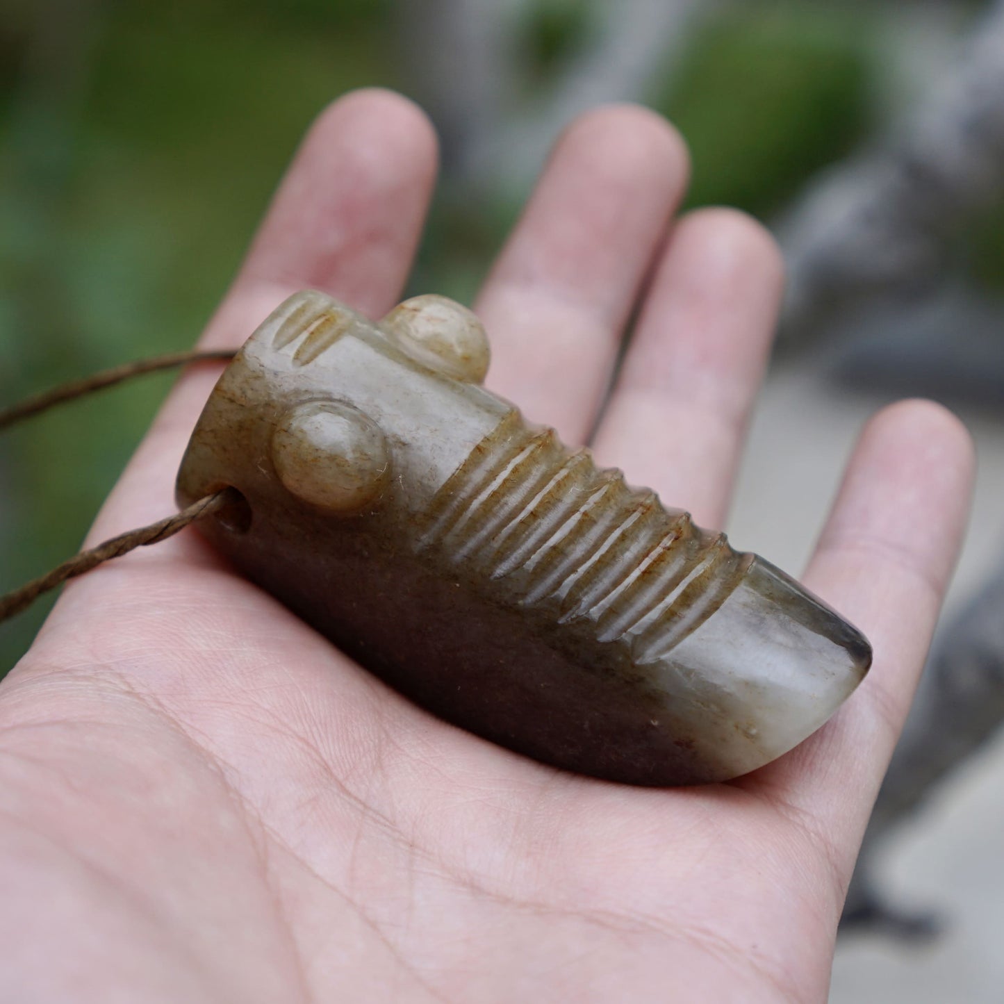 Tubular round sculpture of a jade cicada with convex eyes