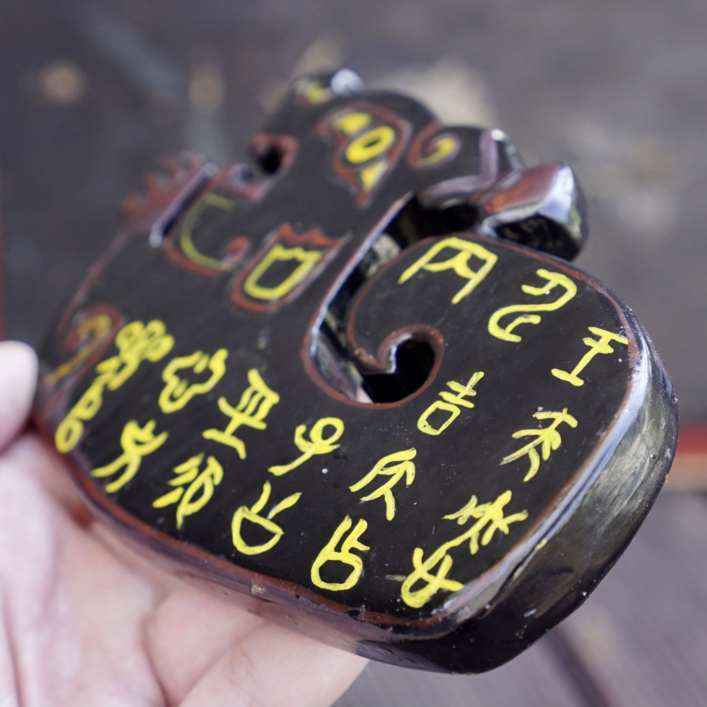 A double-sided lacquer-painted jade tiger with inscriptions