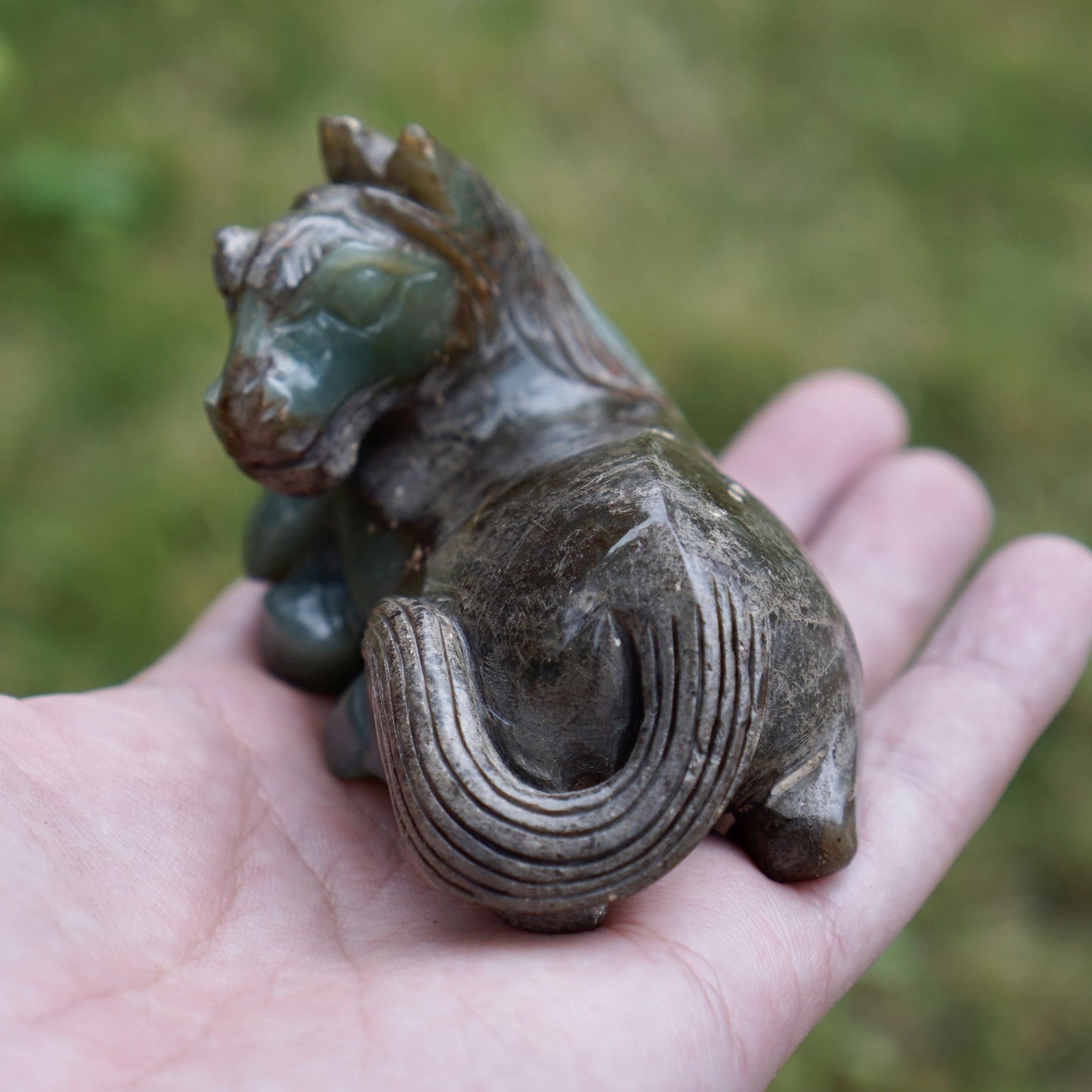 Jade round-carved sculpture of a reclining horse looking back