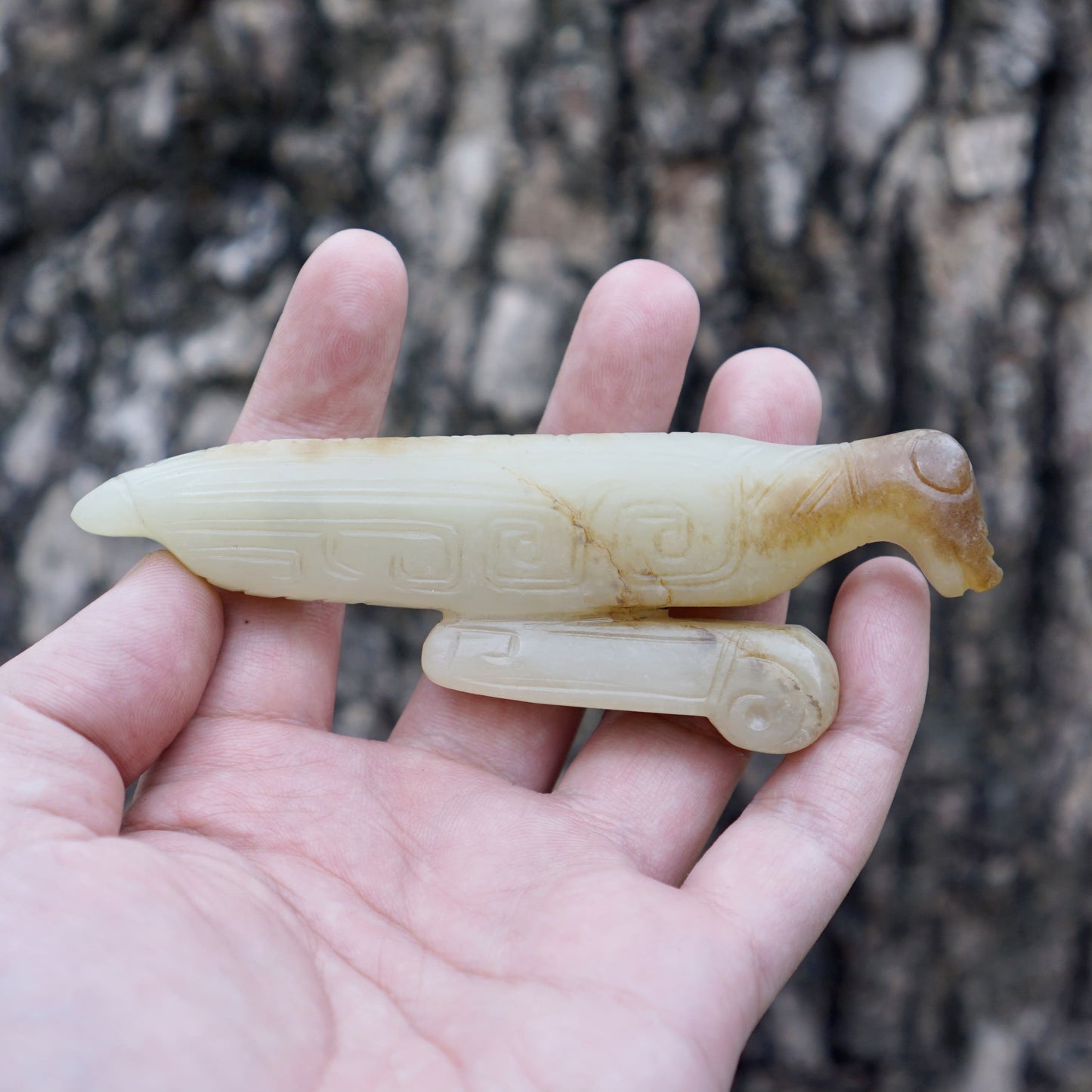 A white jade mantis with an inscription on the back