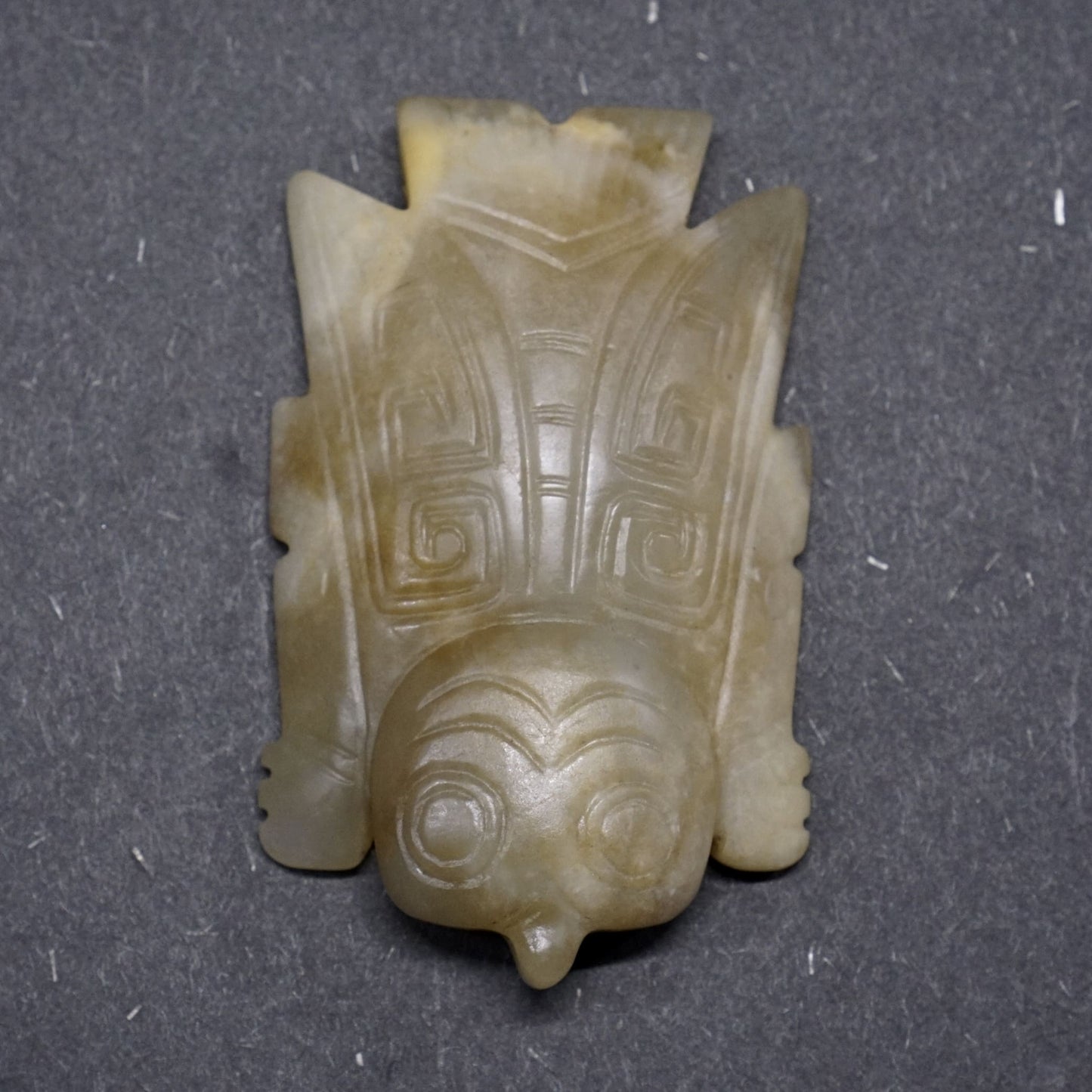 White jade with a circular pattern and a lying bird