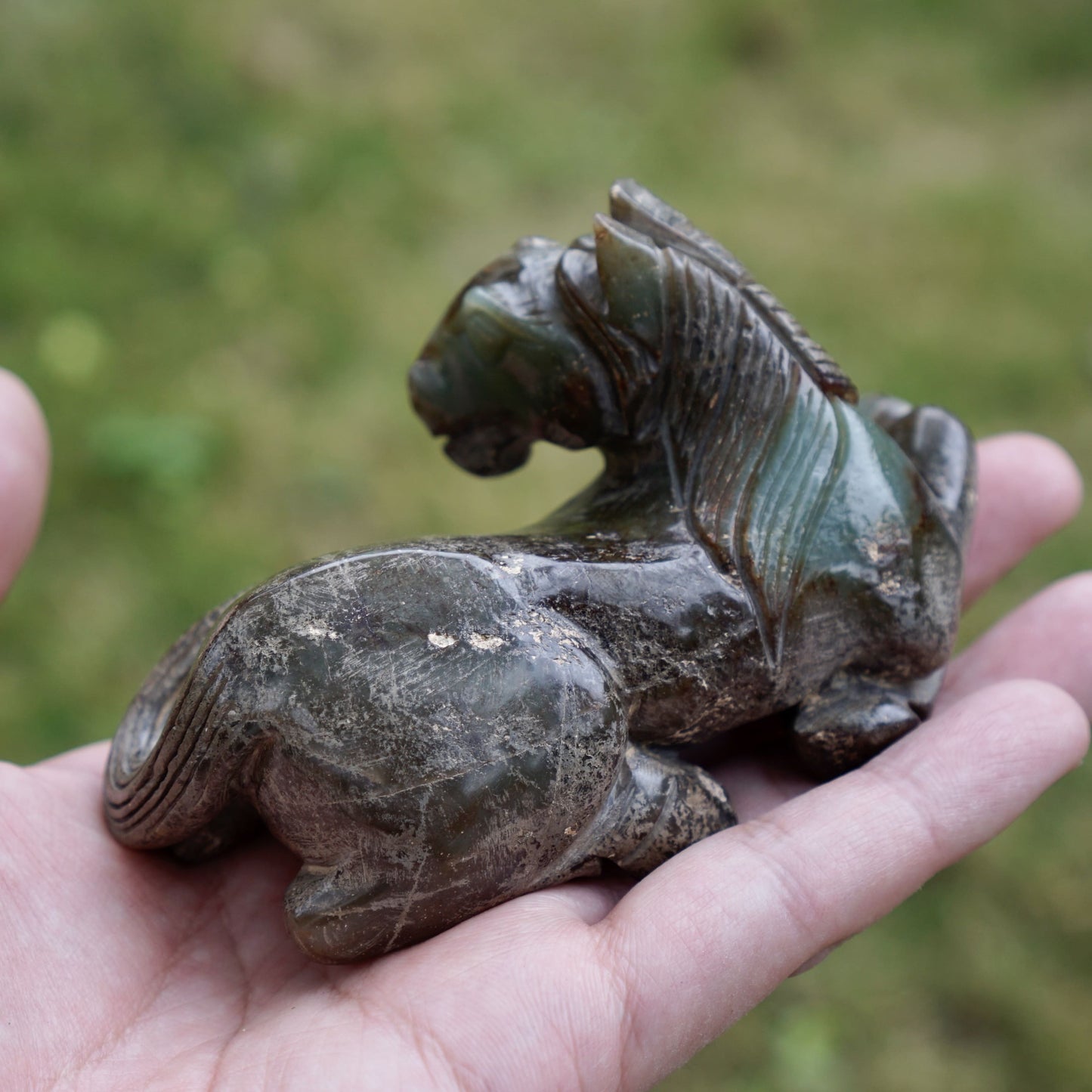 Jade round-carved sculpture of a reclining horse looking back