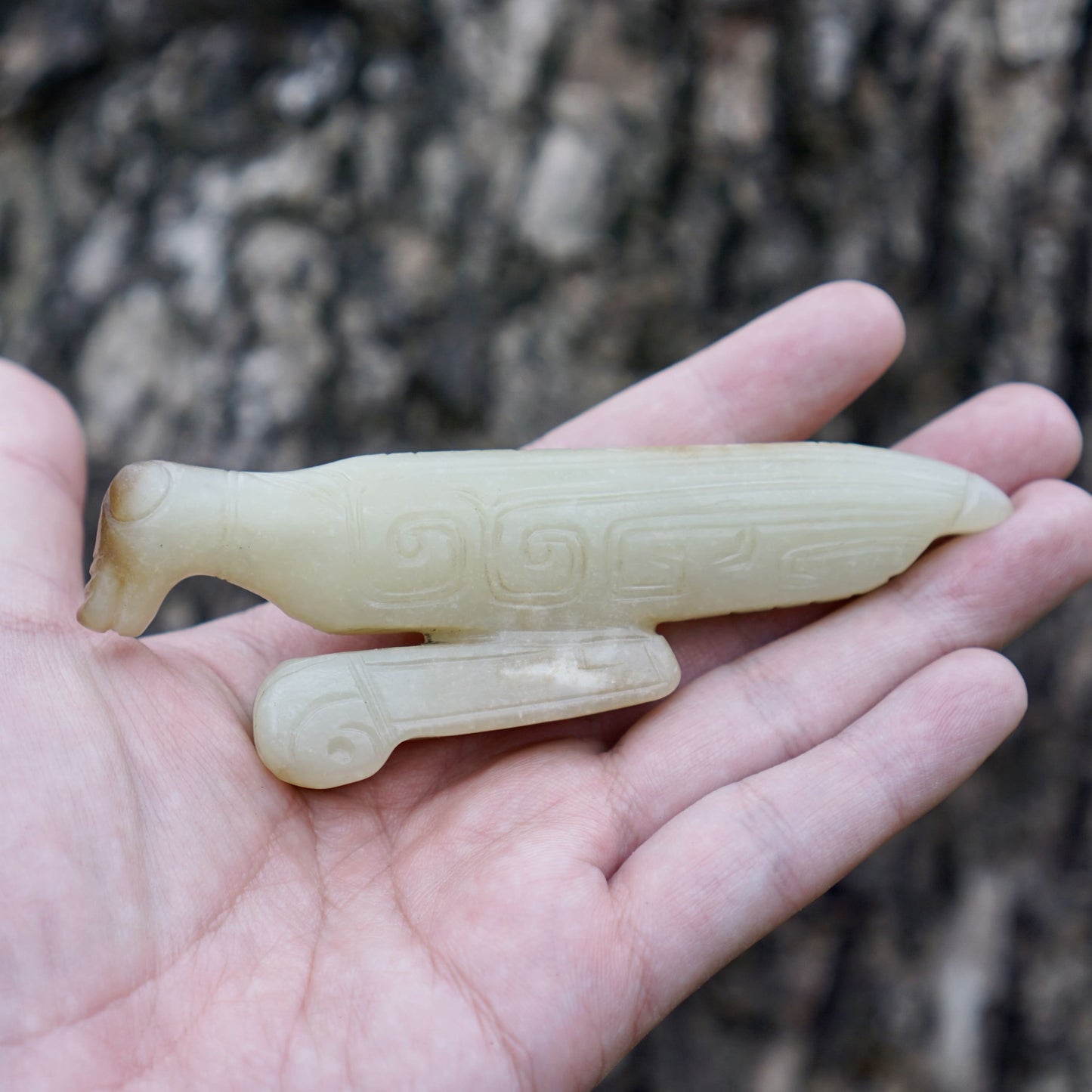 A white jade mantis with an inscription on the back