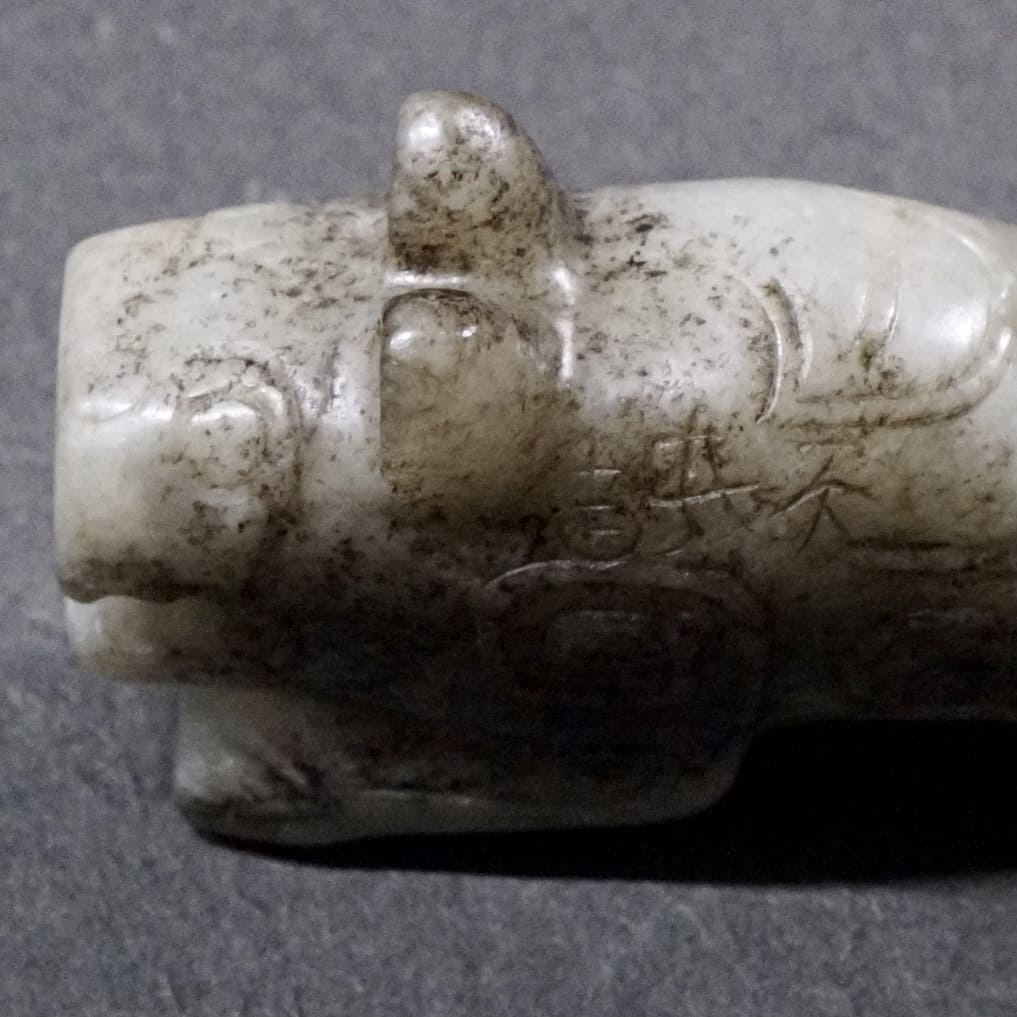 Mercury-stained white jade tiger with inscription