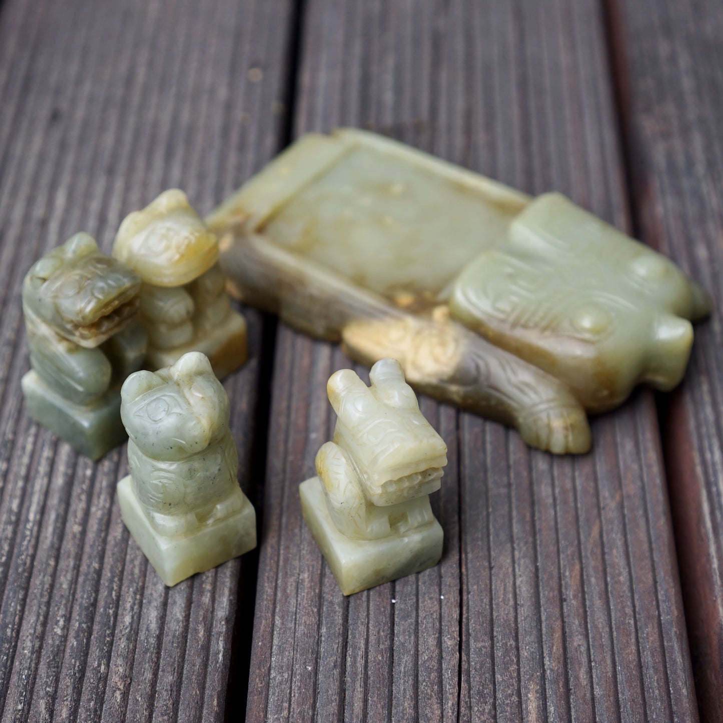 A set of jade seals with a bird carrying four sacred beasts