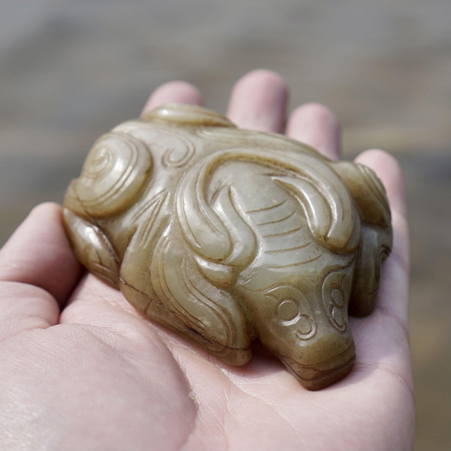 Round carved jade cow paperweight