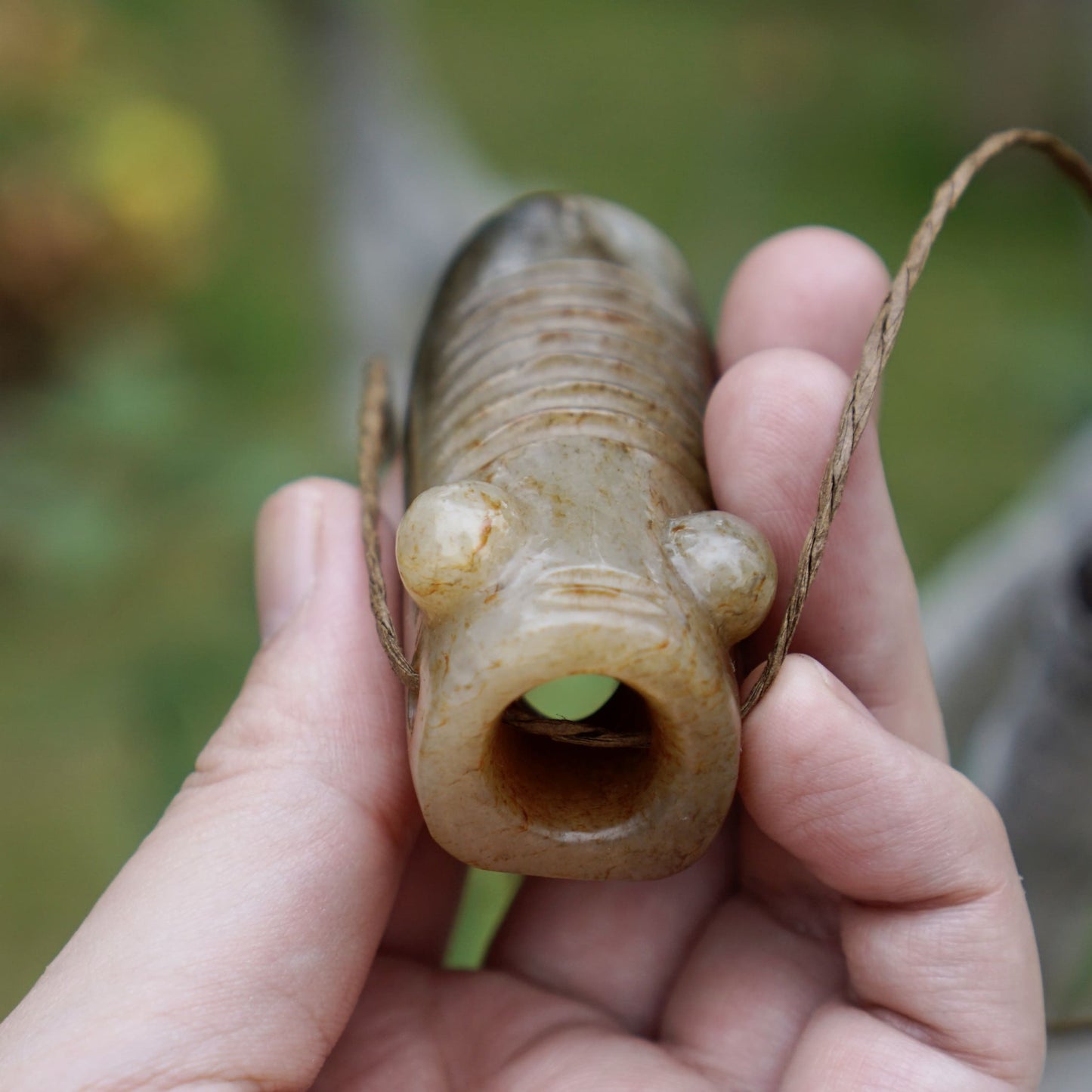 Tubular round sculpture of a jade cicada with convex eyes