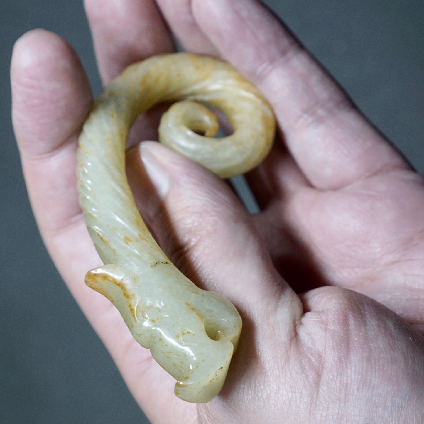 Twisted white jade hook-shaped dragon pendant