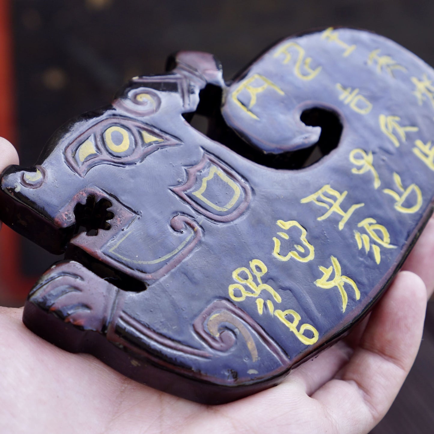 A double-sided lacquer-painted jade tiger with inscriptions