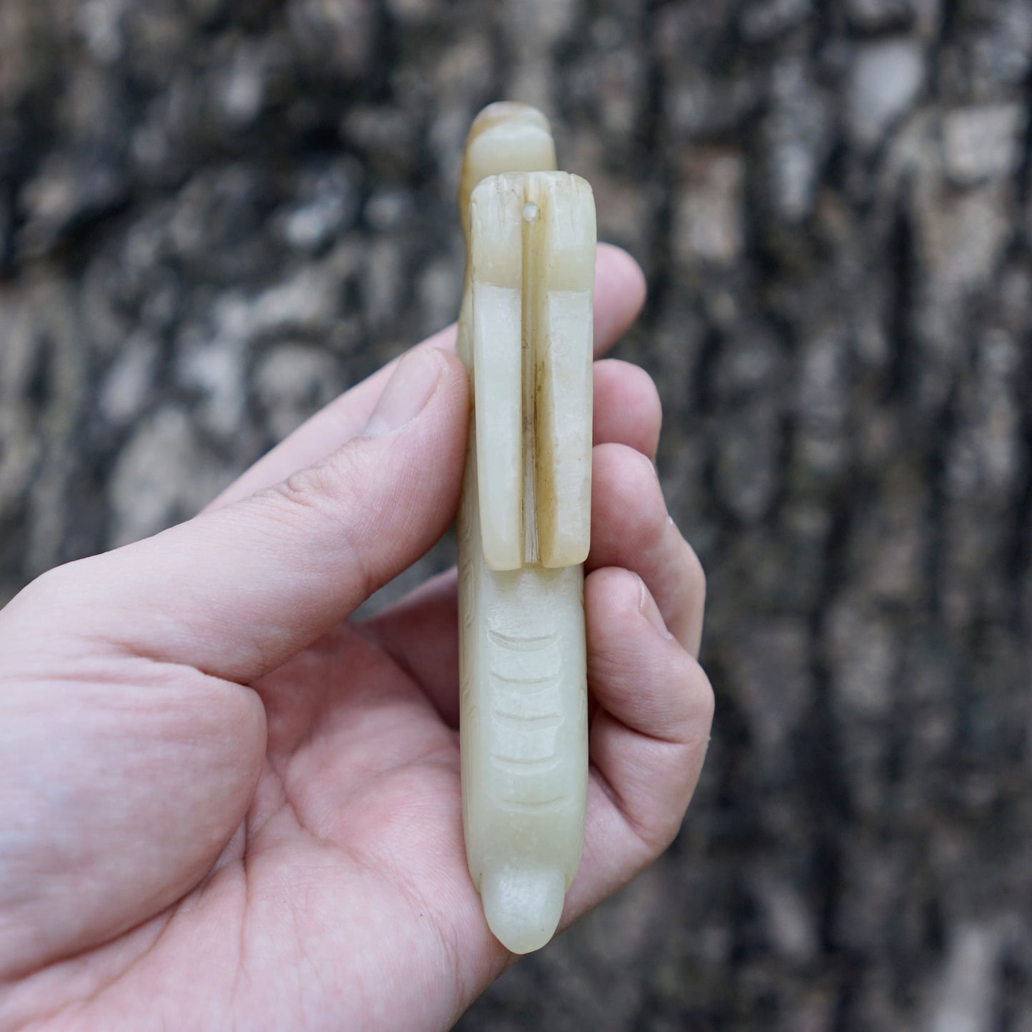 A white jade mantis with an inscription on the back