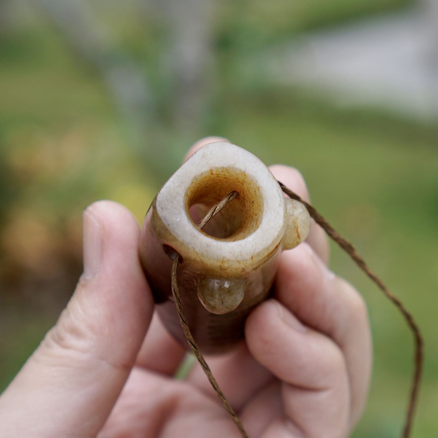 Tubular round sculpture of a jade cicada with convex eyes