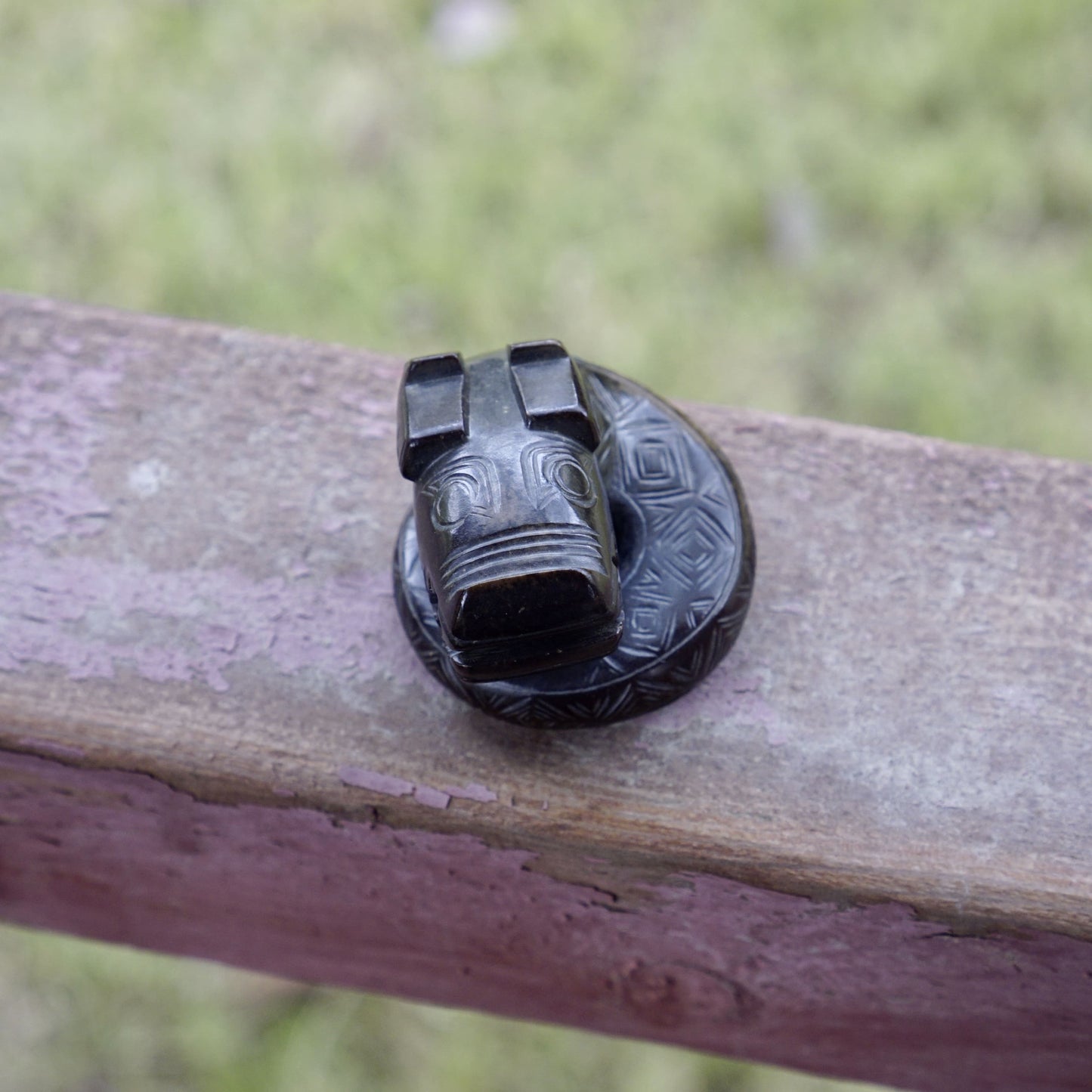 A fine round sculpture of a small dragon with black lacquer